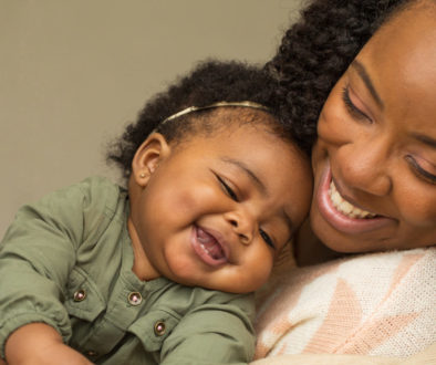 Happy African American mother and daughter playing.