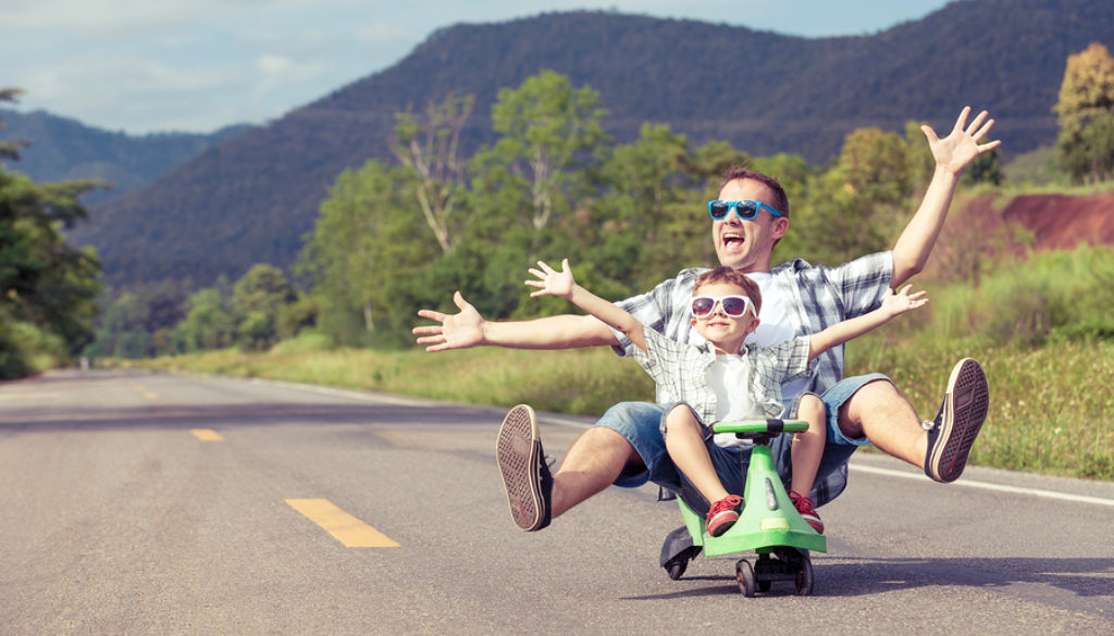 Father And Son Playing On The Road.