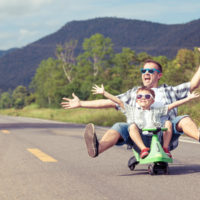 Father And Son Playing On The Road.