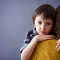 Sad Little Child, Boy, Hugging His Mother At Home