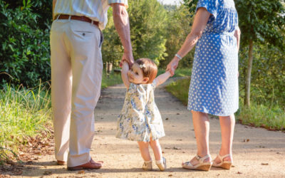 GRANDPARENTS HOLDING GRANDCHILDS HANDS