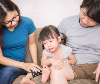 Parents calm crying girl portrait of parents embraces daughter